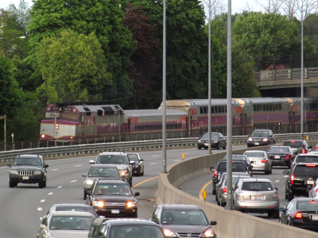 Outbound_train_and_Mass_Pike_at_Auburndale