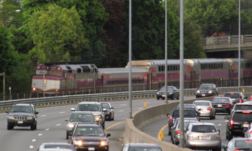 Outbound_train_and_Mass_Pike_at_Auburndale